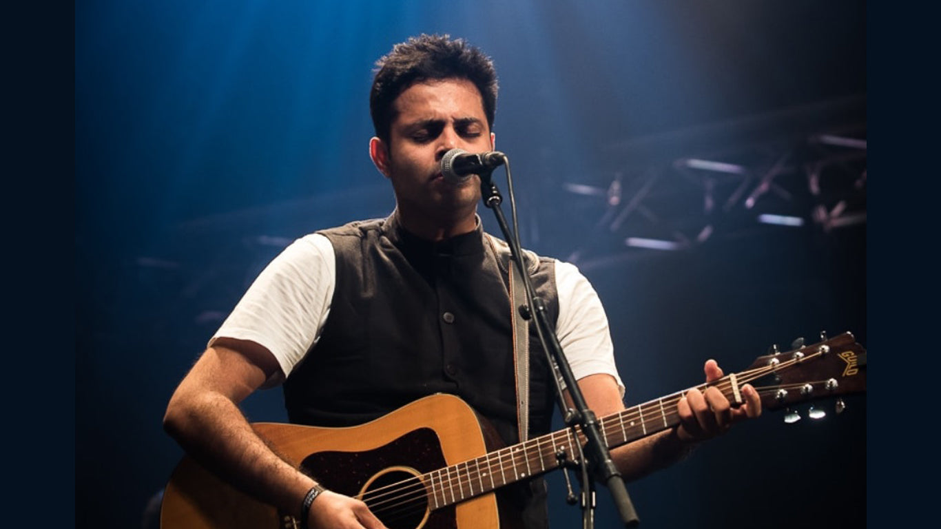 Alluri Playing guitar and singing live on stage