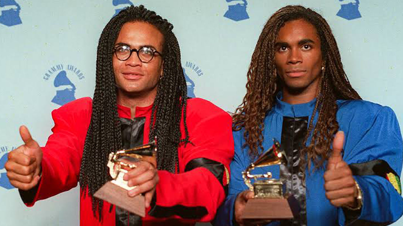 Milli Vanilli thumbs up with an award